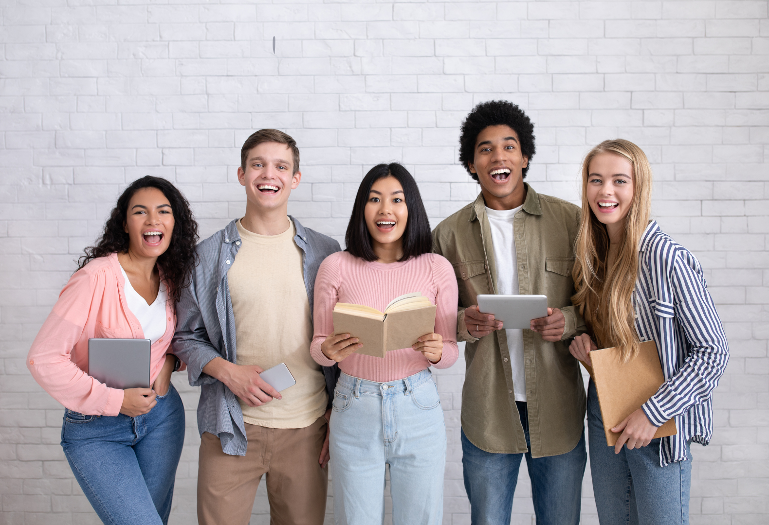 a group of people standing in front of a brick wall