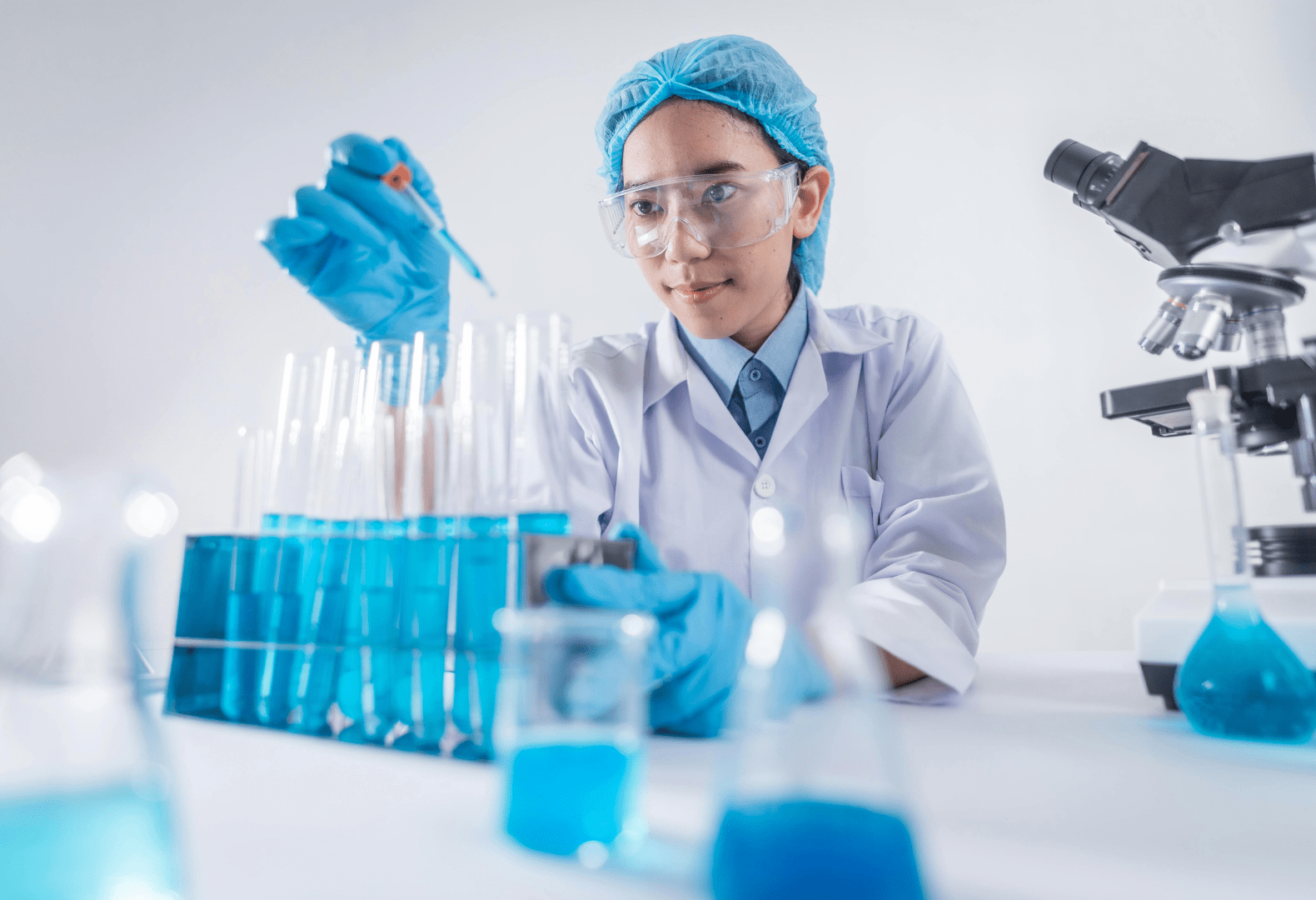 a person in a lab coat is holding a test tube doing an experiment