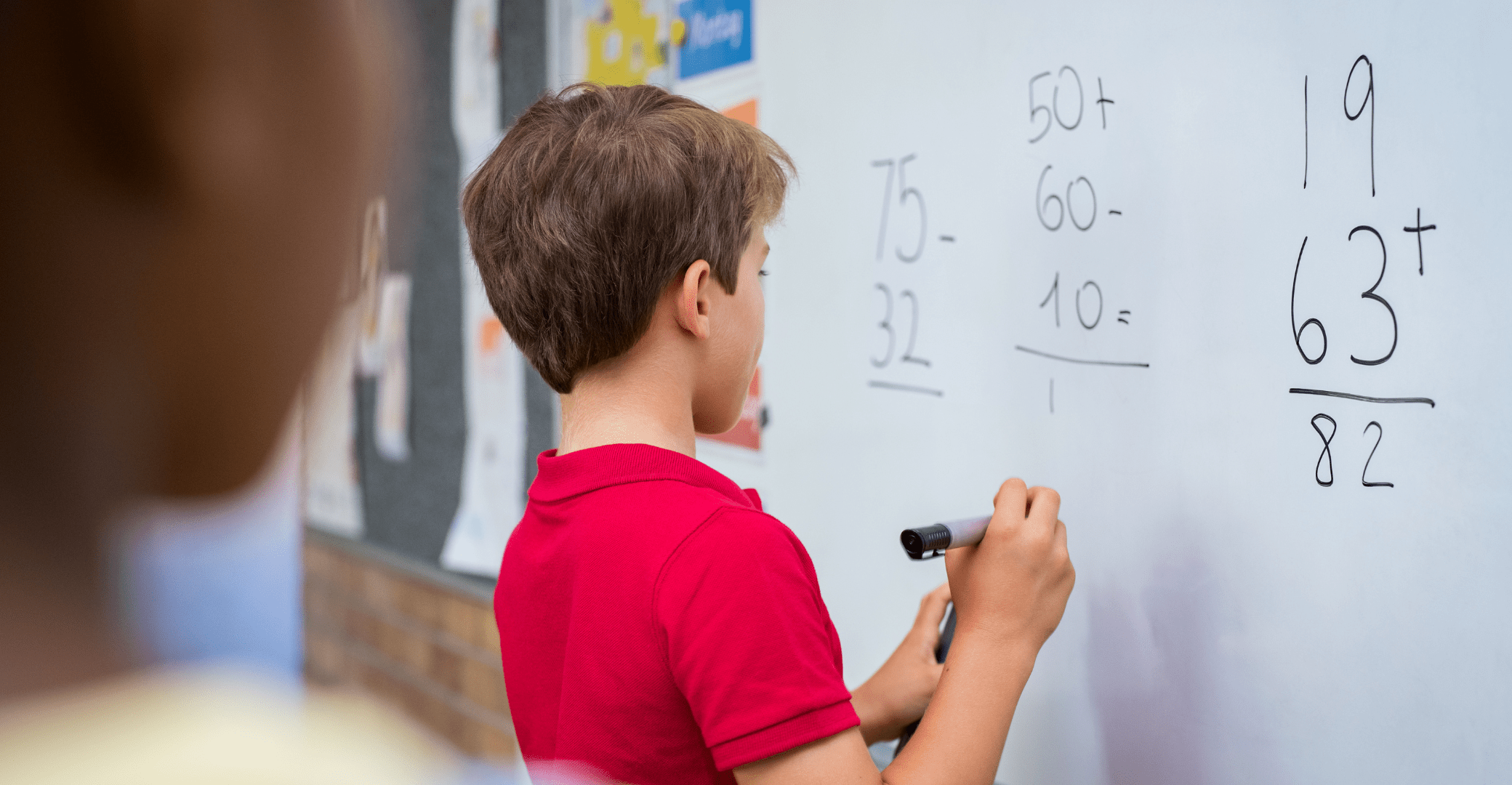 a student solving fractions on a white board