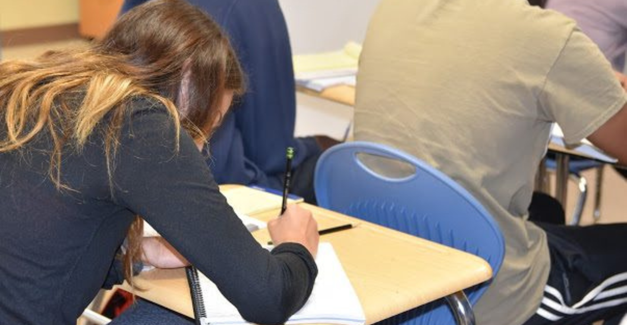 a group of student sitting at desks in a classroom