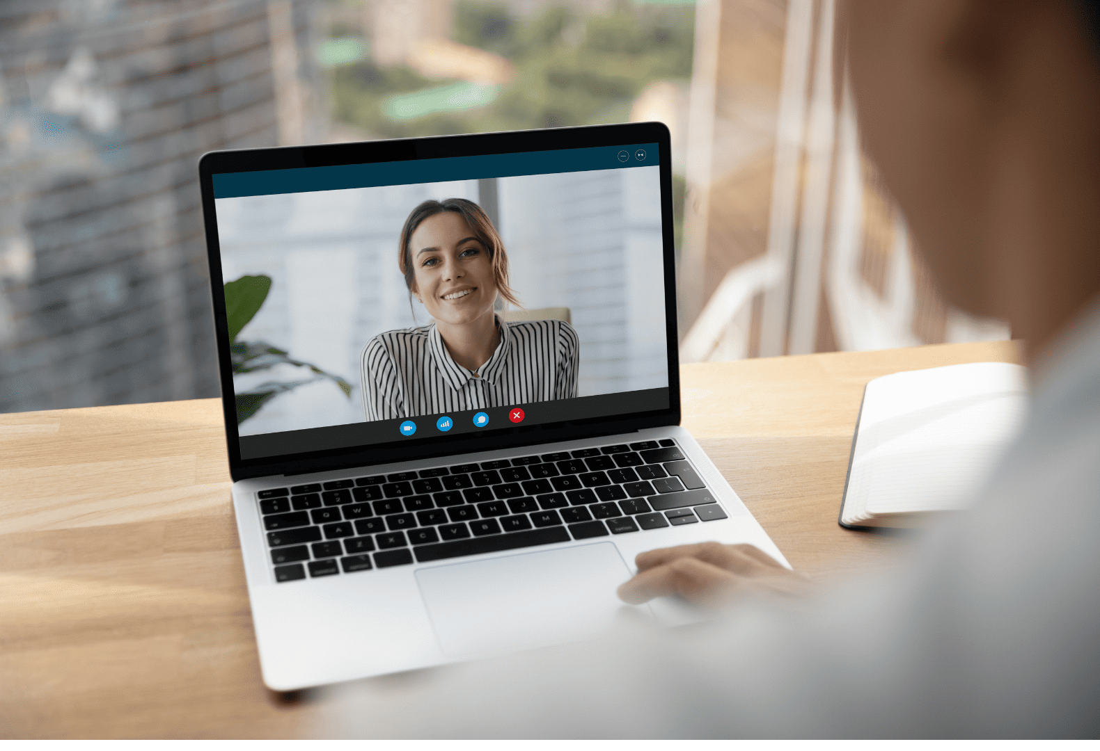 a person using a laptop with a video call on the screen