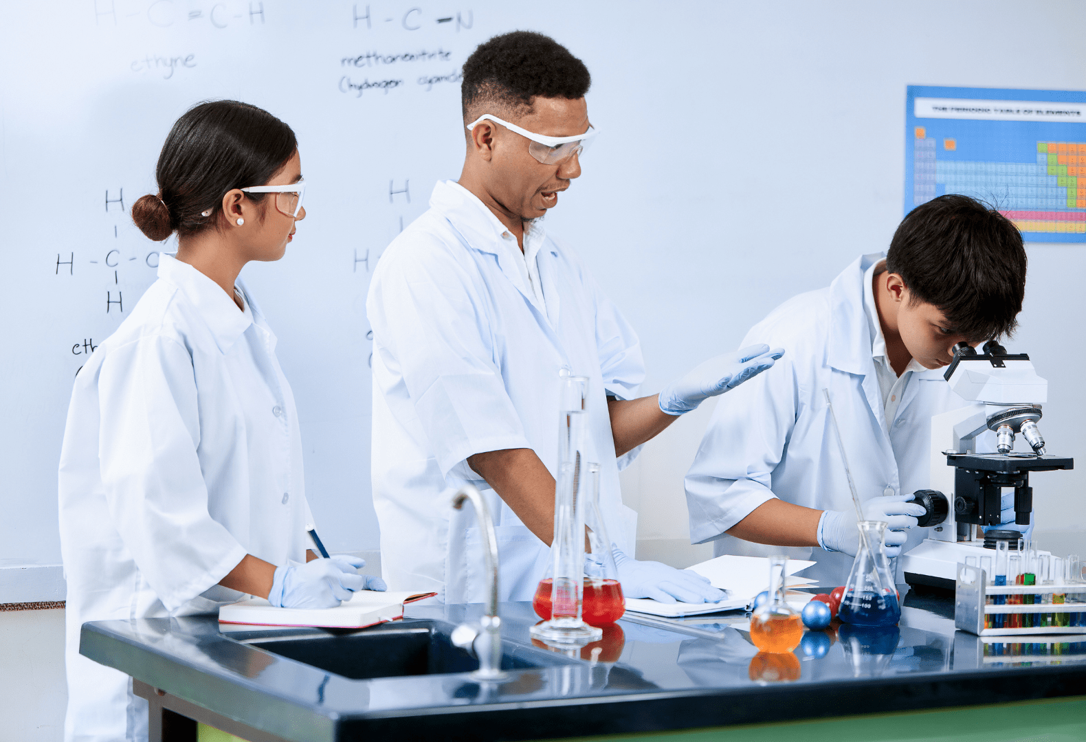 a group of students in lab coats doing experiment